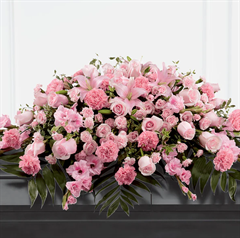 Pastel Rest Casket Spray includes Pink roses, spray roses, carnations and a variety of lush greens