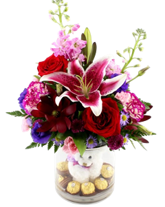 Bunches of Kisses includes roses, lilies, leucadendron, plush bear & chocolates in a clear cylinder